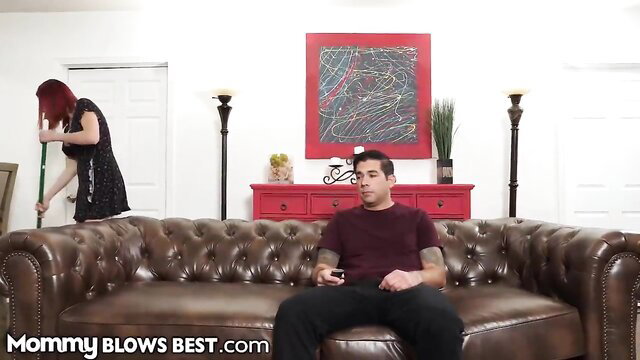 Redhead big tit stepmom in black dress cleans near guy on couch