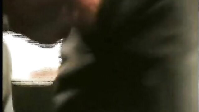 Man in leather jacket closeup, intense gaze in Leather & Law adult scene