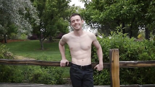 Shirtless fit guy Kollin leaning on fence in jeans outdoors solo tease
