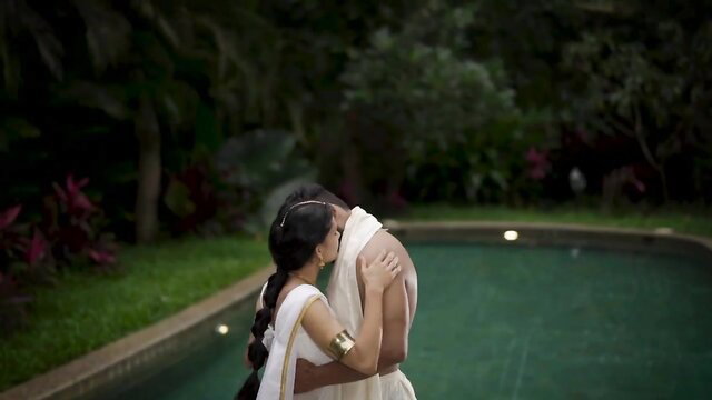 Indian busty MILF in saree embraces nude hunk poolside kiss