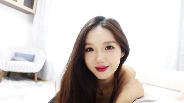 Asian landlady Lingling topless closeup with glossy lips and long hair