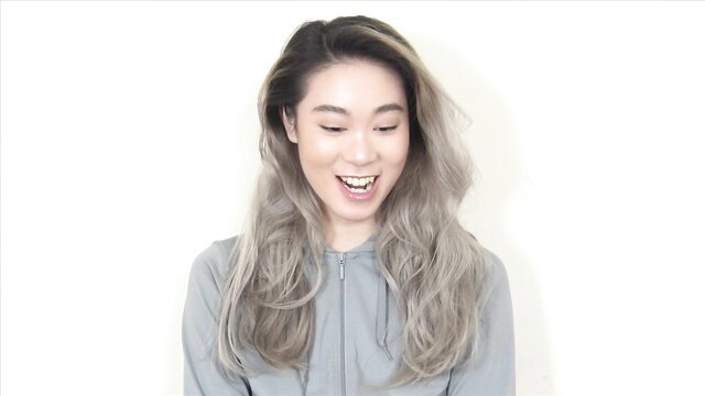 Smiling Asian girl with gray hair in hoodie, tickle fetish tease