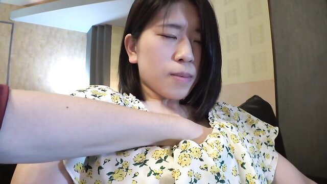 Asian woman choked by hand on neck, floral dress, intense expression