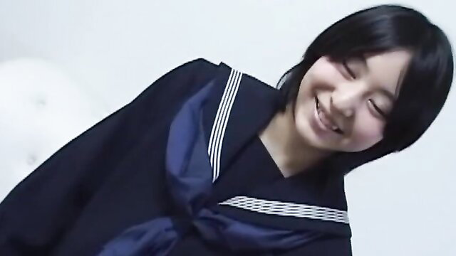 Cute Japanese junior high girl Ami smiling in sailor school uniform