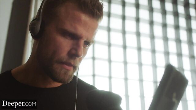 Handsome man with headphones in dark shirt, Deeper studio thumbnail