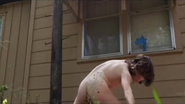 Nude young twink bends over in outdoor water play show