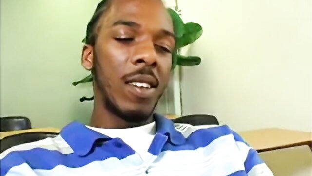 Black teacher in polo shirt sits relaxed teaching student lesson