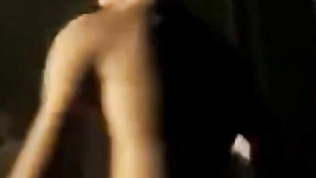 Blurry outdoor shot of muscular young man's bare arm and torso