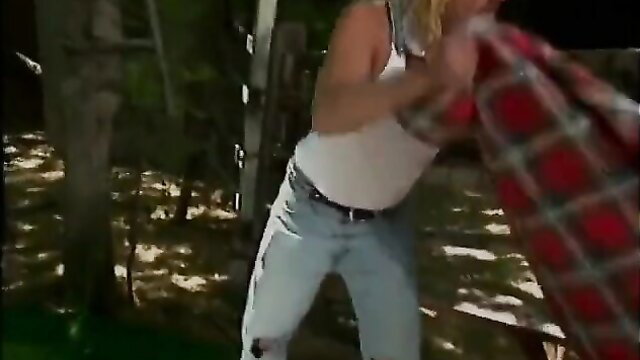 Hot blonde in white tank top and jeans wrestling outdoors