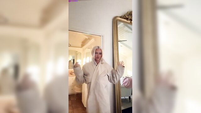 Lindsey Pelas in fluffy white robe, teasing nude October livestream