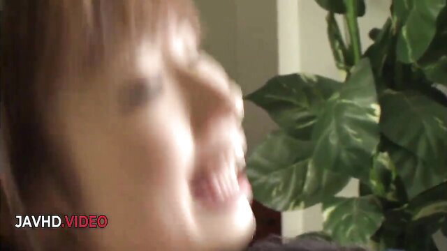 Blurred Asian woman smiling in JAV closeup, explicit adult video thumbnail