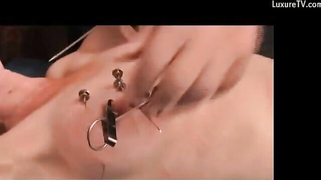 Skinny girl tied up with needles piercing skin in extreme BDSM play