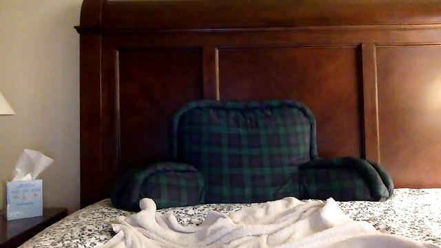 Gay Latino athletic hunk on bed with plaid bedrest pillow