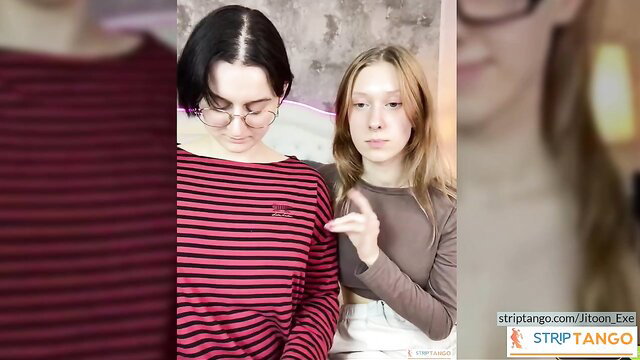 Two young amateur girls in striped tops gesturing intimately at stripTango