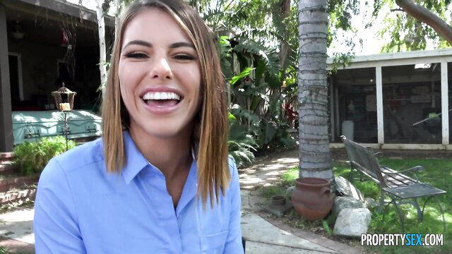 Adriana Chechik smiling in blue blouse outdoors PropertySex