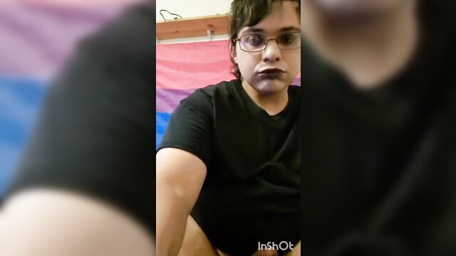 Michael The Femboy closeup selfie in black tee with makeup and pride flag
