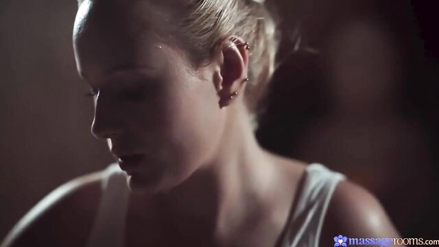 Blonde with big tits in tank top, closeup profile at Massage Rooms