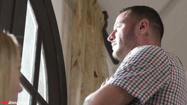 Danny Mountain gazing at petite blonde Maria Kazi by window