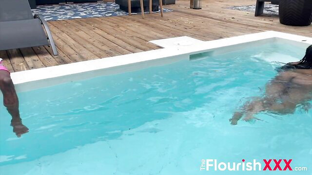 Ebony babe in pink swimsuit splashing nude in pool, wild wet fun