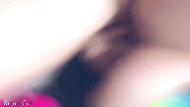 Blurry redhead clown girl in pink wig, heavy makeup, blue top, explicit pose