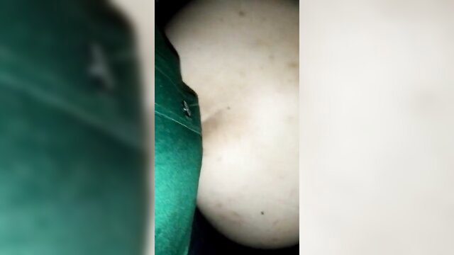 Blurry closeup of mature Brazilian woman's pale breast and green top in amateur hookup thumbnail