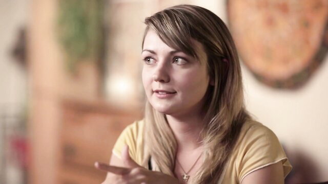 Blonde amateur girl in yellow tank top gestures in solo masturbation tease