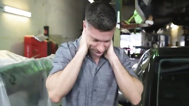 Handsome man in garage grimacing, hands on ears, adult video thumbnail