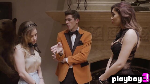 Saucy big tits babes in threesome with suited guy by fireplace