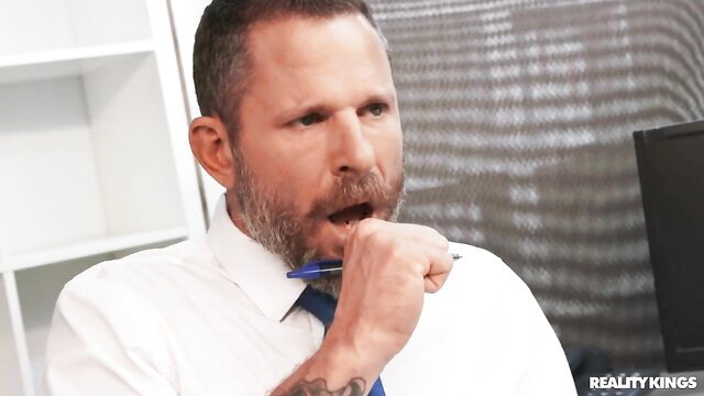Scott Nails in suit holds pen in mouth, Reality Kings office tease
