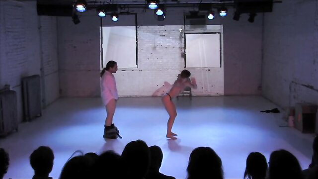 Rebecca Patek bending over nude on stage in live performance