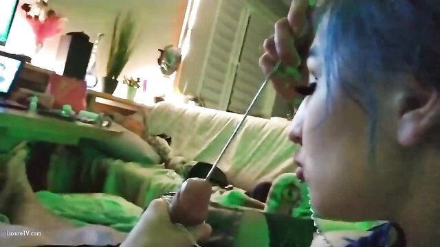 Blue-haired Asian girl sounding her cock with metal rod closeup