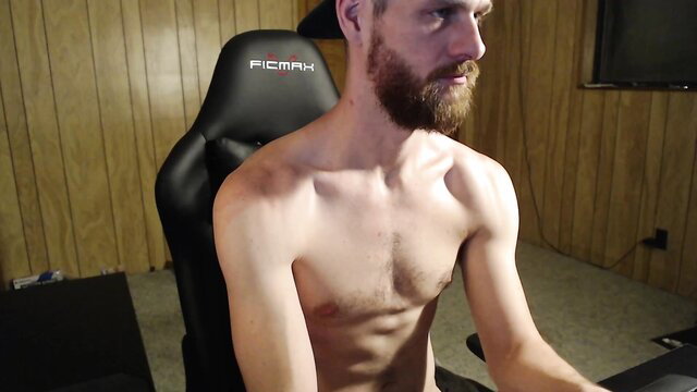 Shirtless muscular bearded white guy in gamer chair, gay amateur tease