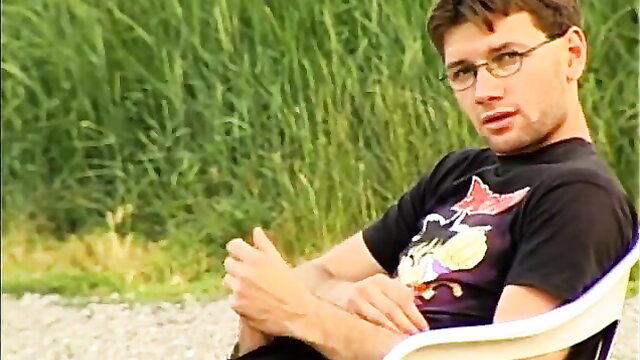 Glasses guy in black anime t-shirt lounging outdoors in lesbian threesome thumbnail