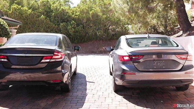 Angel Youngs outside two parked cars in hot scene