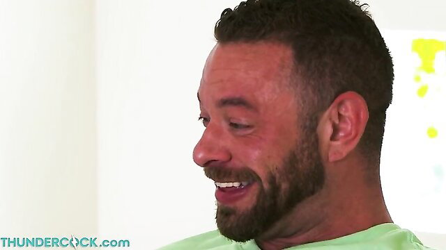 Smiling bearded man in green shirt from Angela White adult video
