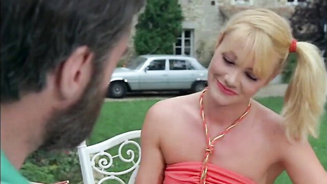 Blonde French Christine in skimpy orange dress outdoor with man