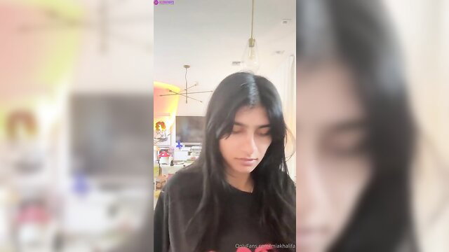 Mia Khalifa talking nude on livestream, black hoodie, dark hair