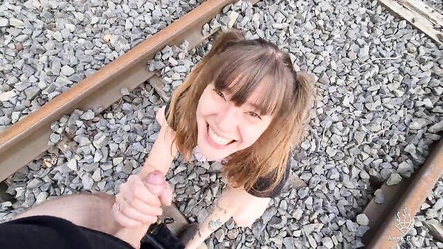 Cute brunette with pigtails gives handjob on train tracks public outdoor