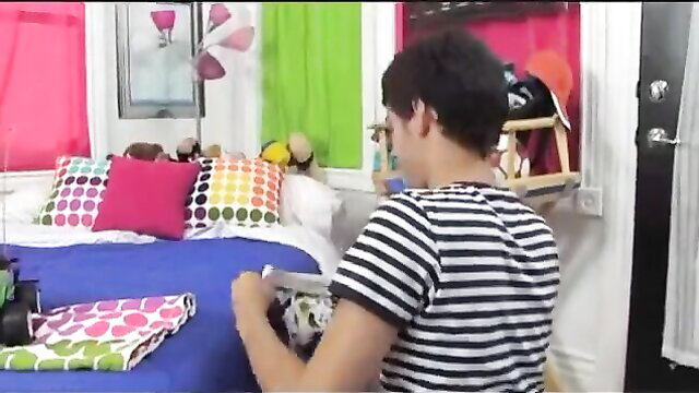 Young man packing clothes on colorful bed in amateur home video