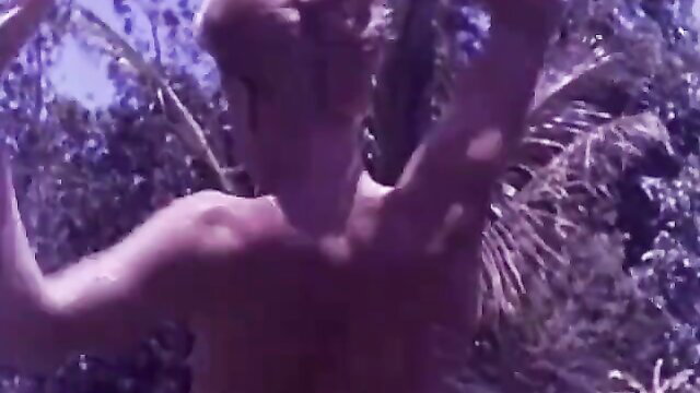 1960s vintage nude man arms raised at nudist resort beach