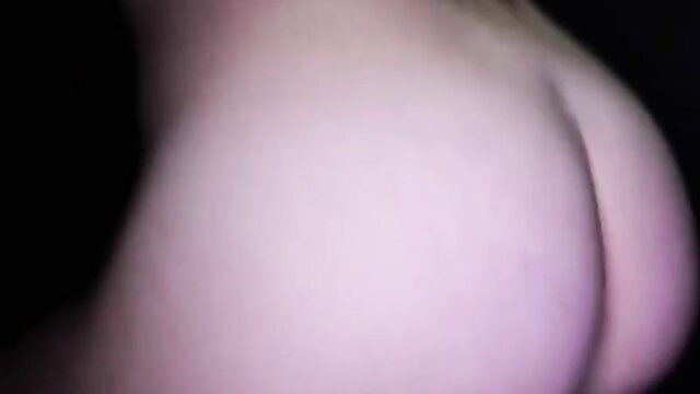 Closeup of pale woman's huge round ass in pink lighting, sexy curves