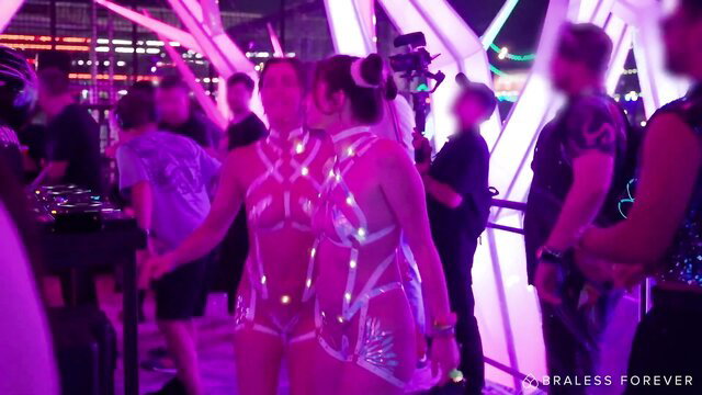 Emma & Lila in glowing body tape outfits dancing at neon rave party