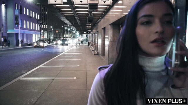 Emily Willis on phone in neon-lit alley, Vixen Plus