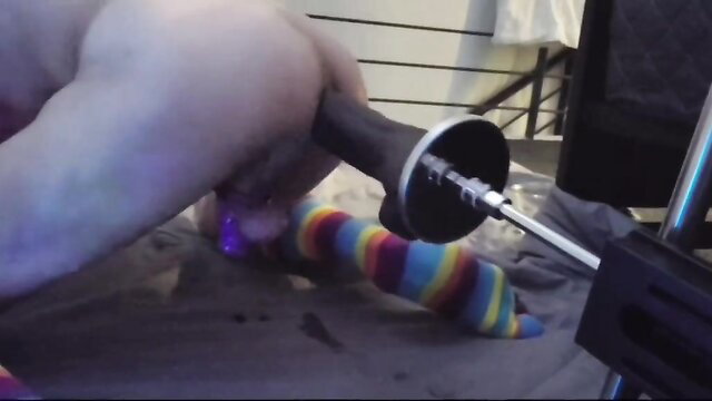 Muscular guy in colorful socks fucking fleshlight on bed closeup