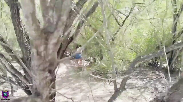 Yiny Leon busty MILF walking in lush green woods wearing blue shorts