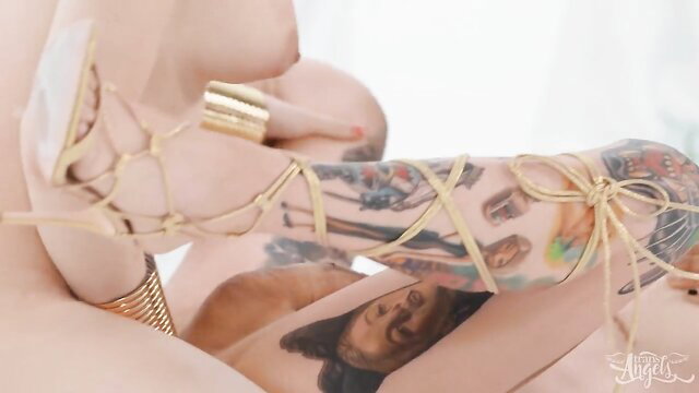 Skinny tattooed shemale in ropes gets anal fucked intensely