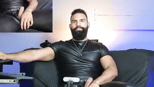 BeardAndrew muscular bearded hunk in tight black leather holds Wii remote