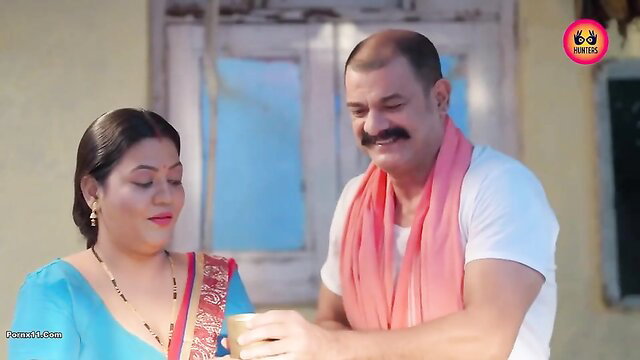 Indian MILF in blue saree offers tea to smiling man, softcore tease