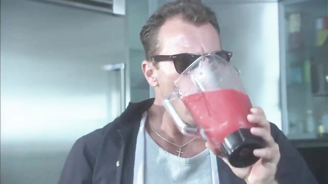 Monica Mayhem drinks red smoothie from blender in kitchen