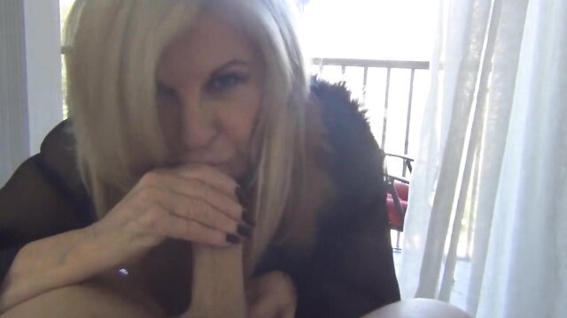 Blonde mature MILF sucking cock closeup on balcony